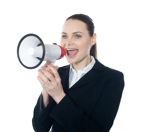 Pretty lady giving instructions with megaphone — Stock Photo, Image