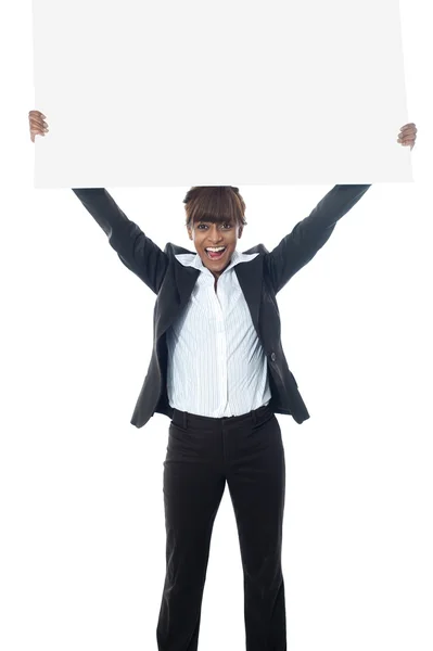 Glada affärskvinna poisng med skylt — Stockfoto