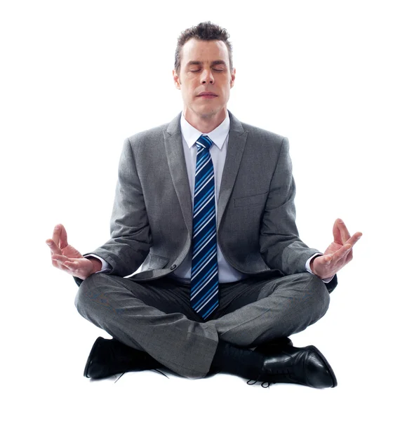 Businessman meditating in lotus position — Stock Photo, Image