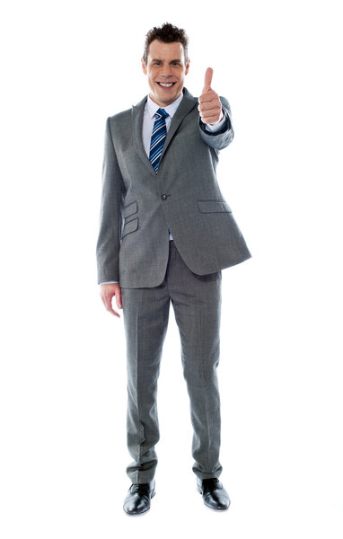 Confident businessman gesturing thumbs up