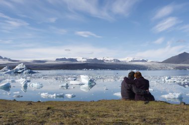 enjoying the icebergs in Jokulsarlon, Iceland clipart