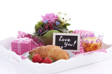 Delicious breakfast and a lovely present on a tray clipart