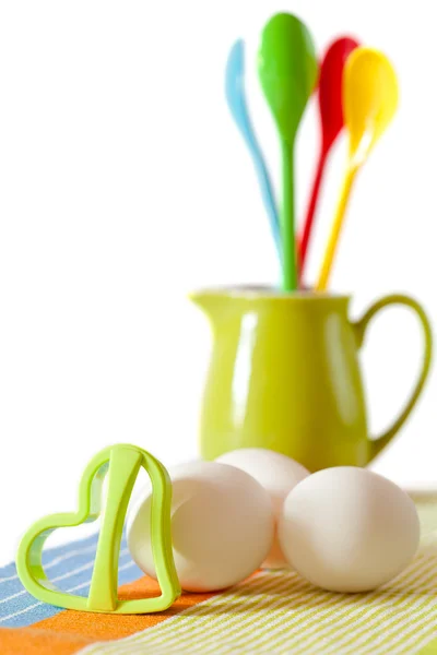 Cookies making: fresh eggs, green jug, spoons and cookie form is — Stock Photo, Image