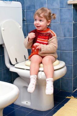 Child on the toilet clipart