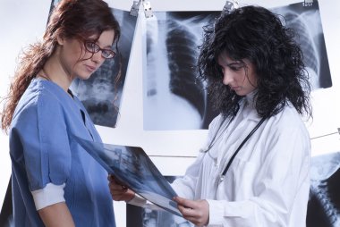 Doctors examine x-rays clipart