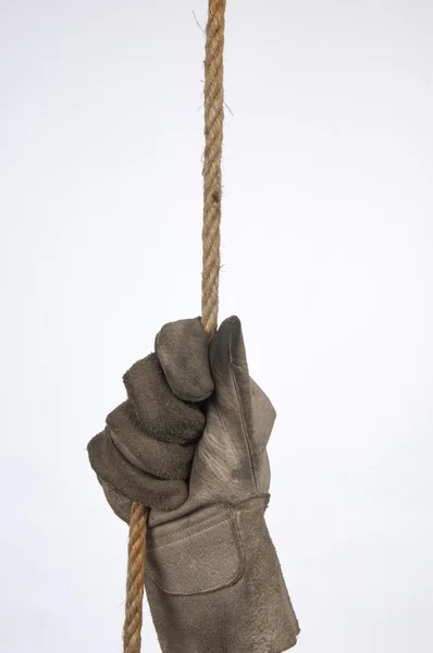 Hands of workers hanging from a rope — Stock Photo, Image