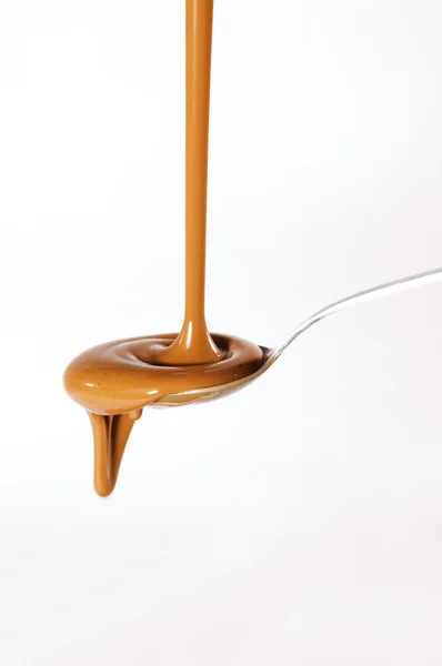 Liquid chocolate on spoon — Stock Photo, Image