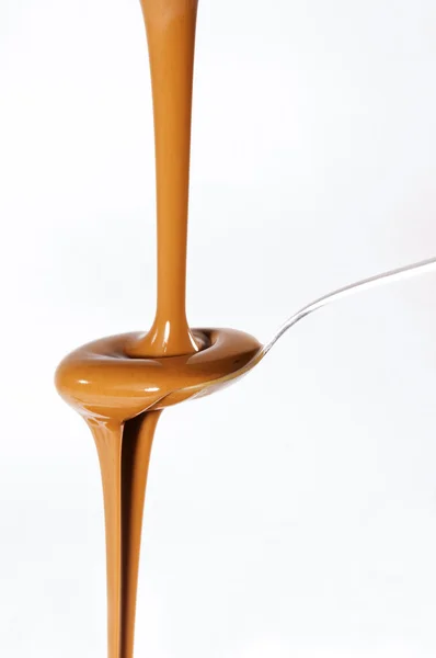 Liquid chocolate on spoon — Stock Photo, Image