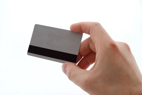 Рука з банківською карткою на білому тлі на великі шматочки Ліцензійні Стокові Зображення