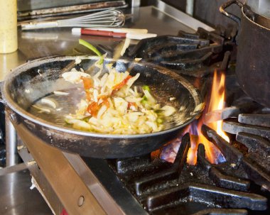 Vegetables Being Tossed in Skillet clipart