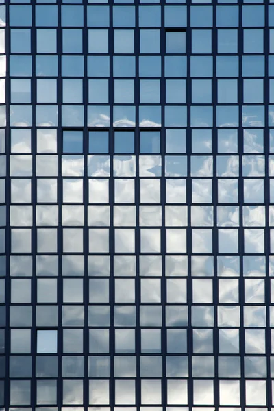 stock image Mirror reflection of clouds in windows of a building