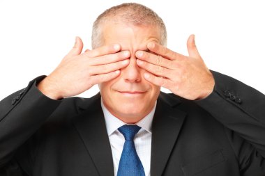 Portrait of business man covering eyes clipart