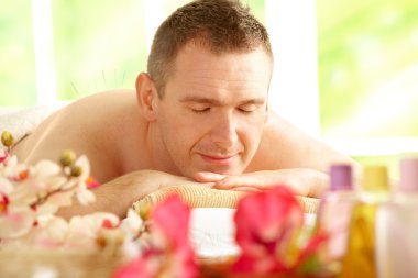 Man getting acupuncture treatment in a spa clipart