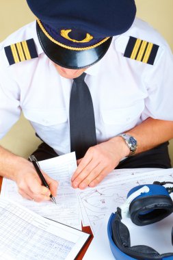 Airline pilot filling in papers clipart