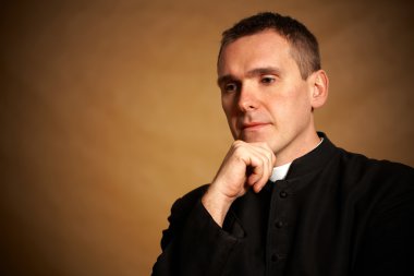 Priest with hand under chin clipart