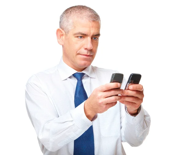 Biznesmen z dwoma telefonami na białym tle — Zdjęcie stockowe