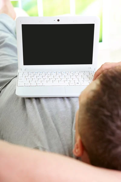 Человек расслабляющий с ноутбуком — стоковое фото