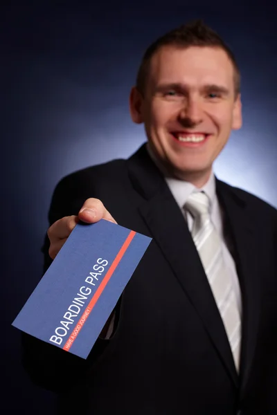 Business man holding a boarding pass — Stock Photo, Image