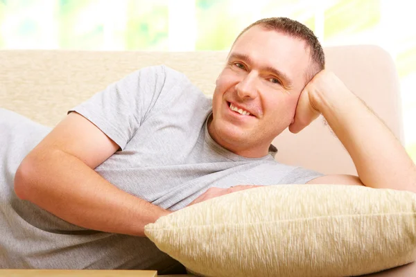 Man relaxing on sofa — Stock Photo, Image