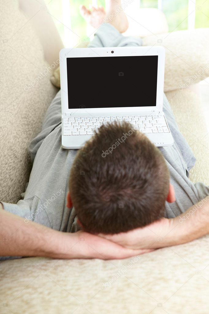 Man using laptop in home