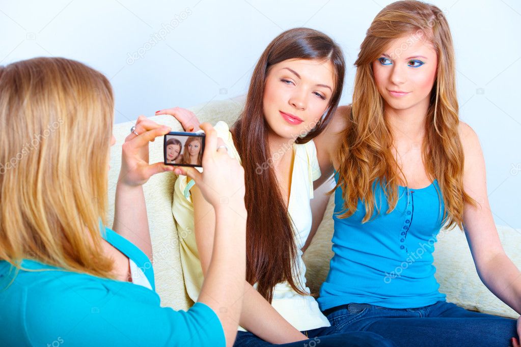 Three girls taking photos
