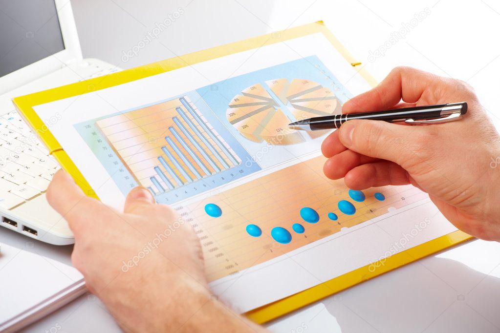 Business graphs and male hands