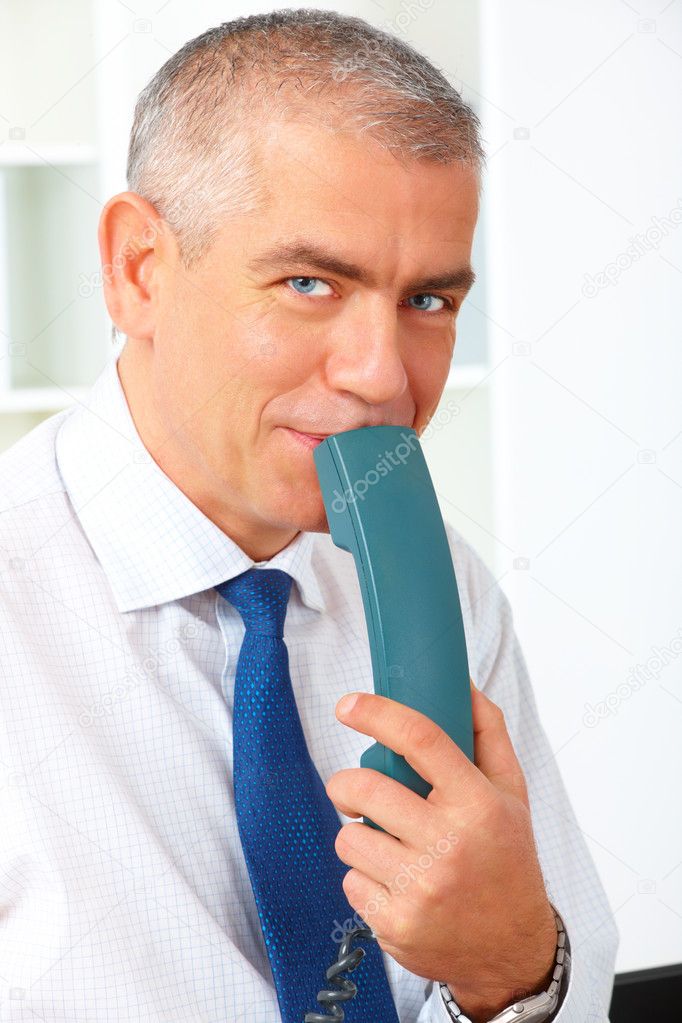 Happy businessman with phone