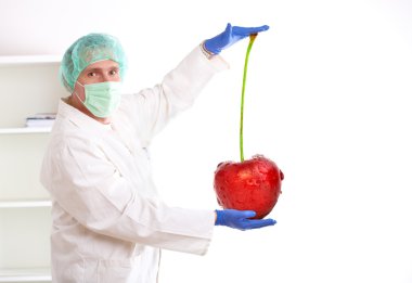 Researcher holding up a GMO fruit clipart