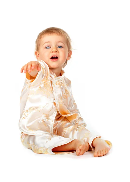 Baby girl sitting and pointing — Stock Photo, Image