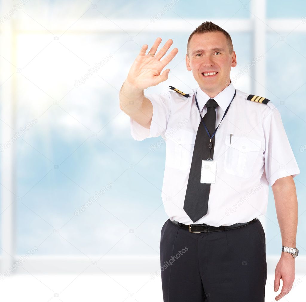Airline pilot waving