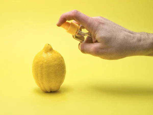 stock image Applying glycerin to a lemon on yellow background