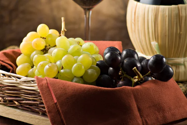 Grapes, bottle and a glass of wine — Stock Photo, Image