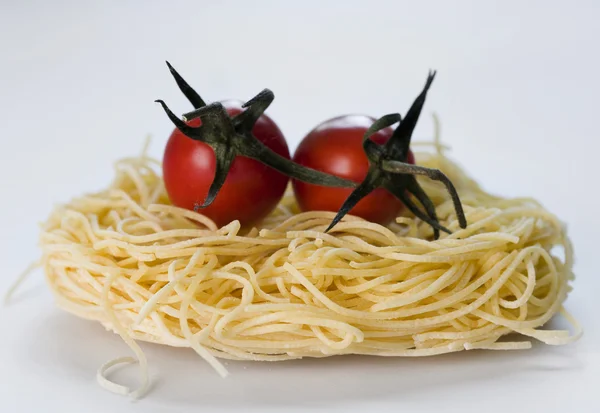 Pasta and two tomatoes — Stock Photo, Image