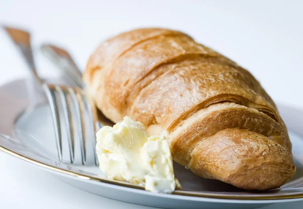 Croissant with butter — Stock Photo, Image