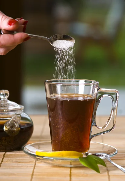 Glass of tea with sugar — Stock Photo, Image