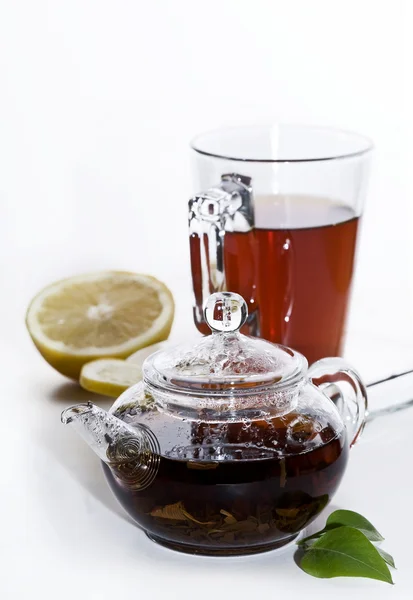 Glass of tea with teapot — Stock Photo, Image