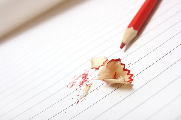 Red crayon on lined paper — Stock Photo, Image