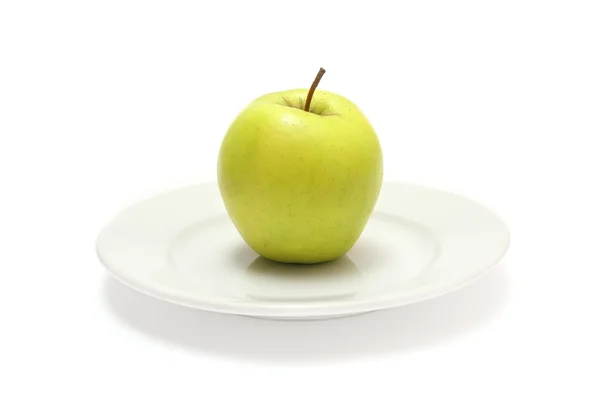 Apple on white plate — Stock Photo, Image