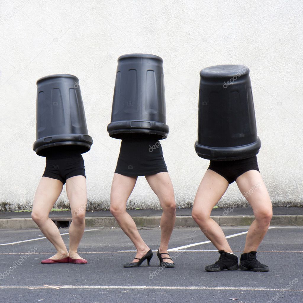 Three trash cans cover three women heads