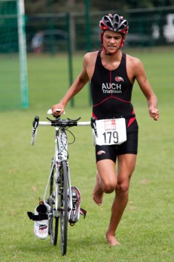 Competitor barefoot, triathlon. clipart