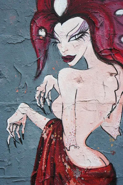 Seltsame rote nackte Frau auf einem Graffiti. — Stockfoto