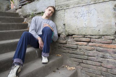 Homeless man resting. clipart