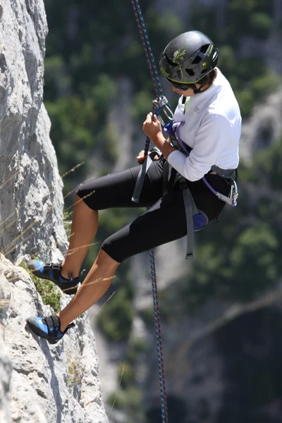 Descida de uma jovem alpinista feminina — Fotografia de Stock