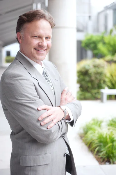 Portrait of a confident mature businessman standing outside — Stock Photo, Image