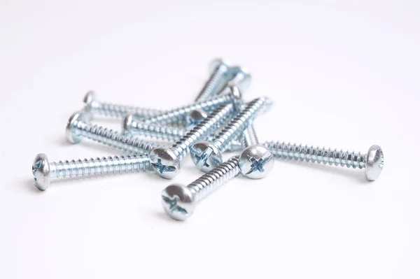 Heap of screws closeup on white background — Stock Photo, Image