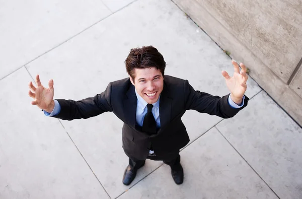 Young businessman with arms open celebrating — Stock Photo, Image