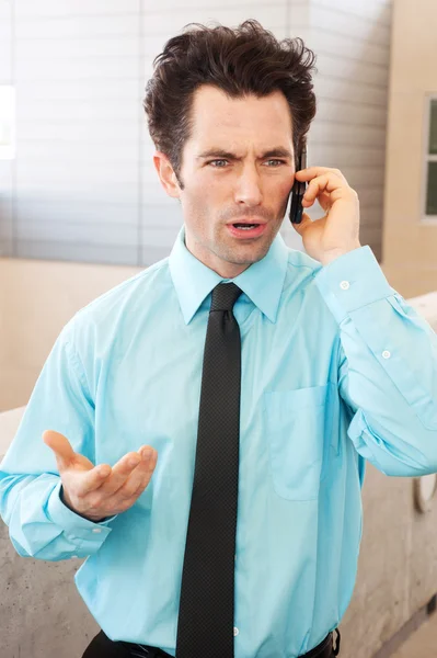 Frustrated executive on cell phone — Stock Photo, Image