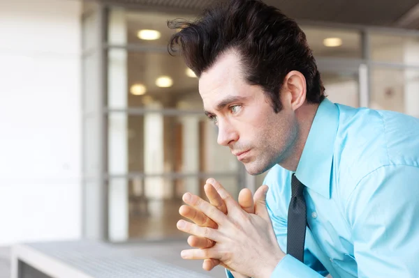 Frustrated businessman sitting on a bench — Stock Photo, Image