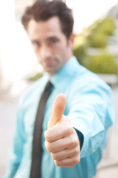 Male executive giving thumbs up — Stock Photo, Image