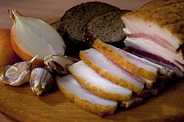 Sliced lard with onion and garlic — Stock Photo, Image